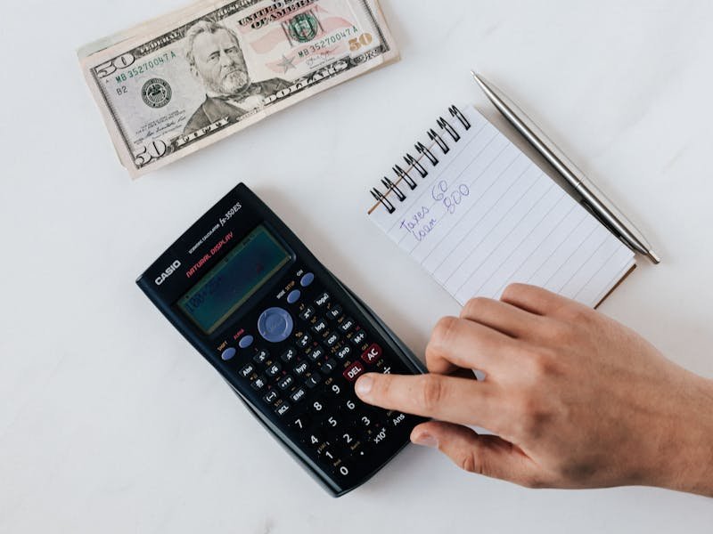 Stacked firewood from a tree removal job saved by a Huntsville homeowner to reduce costs