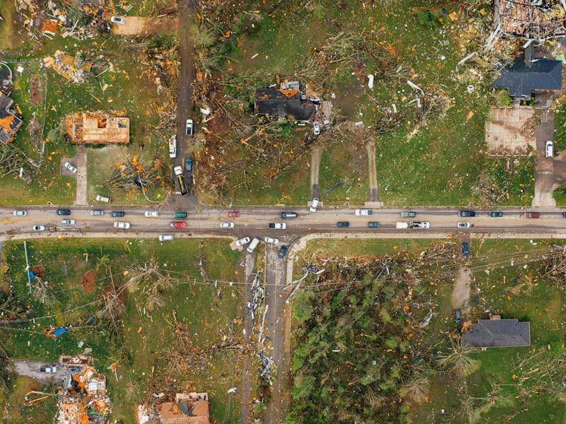 Wood chips and debris from tornado-damaged tree cleanup on a North Alabama residential street
